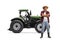 Full length portrait of a farmer with a straw hat and rubber boots posing in front of a tractor