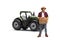 Full length portrait of a farmer with tractor and a crate of apples