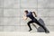 Full length portrait of a fitness man running on the street. Striving for victory