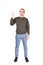 Full length portrait of friendly young man, smiling broadly, waving palm raised up, greeting friends, saying hello. Carefree