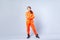 Full length portrait of hip-hop dancer, serious teenage girl standing with crossed hands, youth fashion. studio shot