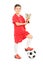 Full length portrait of junior football player holding a trophy