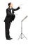 Full length portrait of a male orchestra conductor directing wit