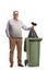 Full length portrait of a mature man throwing a black plastic bag in a bin