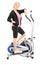 Full length portrait of a mature woman athlete on a cross trainer fitness machine