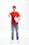 Full length portrait of optimistic delivery man in red t-shirt a