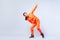 Full length portrait of positive energetic teen girl dancing hip-hop and pointing up with finger pistol, white background