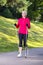 Full Length Portrait of Positive Sportive Senior Woman Doing Nordic Walking in Park