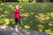 Full Length Portrait of Positive Sportive Senior Woman Doing Nordic Walking in Park