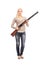 Full length portrait of a serious girl holding a shotgun