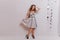 Full-length portrait of shapely woman in party dress  on white background. Indoor photo of blissful cute girl