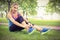 Full length portrait of smiling woman tying shoelace