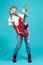 Full Length Portrait of Strong Winsome Caucasian Guitar Player With Red Shiny Bass Guitar Posing In Casual White Shirt And