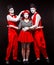 Full length portrait of three mime artists, isolated on black background. Woman and two men stand side by side