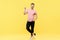 Full length portrait of trendy handsome man show victory sign on yellow background