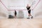 Full-length portrait of two young sportive boys training together, playing squash  over sport studio background