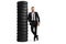 Full length portrait of a young businessman leaning on a pile of tires