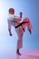 Full-length portrait of young caucasioan sportsman practising martial art of karate, judo, taekwondo isolated on