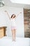 Full length portrait of a young cheerful jumping on bed indoors