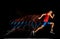 Full-length portrait of young male athlete, professional runner in motion  over black background. Developing