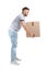 Full length portrait of young man lifting carton box