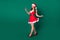Full length profile photo of attractive santa secretary helper lady read telephone email online orders delivery service