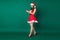 Full length profile photo of attractive santa secretary helper lady read telephone email online orders delivery service