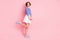 Full length profile photo of cute girl blow air kiss wear striped shirt short skirt sneakers isolated pastel pink color