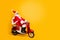 Full length profile photo of santa white hair grandpa riding speed x-mas party by bike wear trendy sun specs red coat