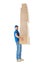 Full length profile portrait of courier carrying stack of boxes