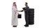 Full length profile shot of an auto mechanic shaking hands with an arab man in a thobe