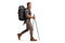 Full length profile shot of a bearded guy hiker with a backpack and hiking poles walking