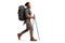 Full length profile shot of a bearded man with a backpack and hiking poles walking