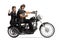 Full length profile shot of a biker riding a young woman on a chopper and showing thumbs up