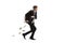 Full length profile shot of a businessman running and holding a briefcase full of money