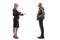 Full length profile shot of a businesswoman standing and talking to a bald punk man