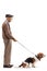 Full length profile shot of an elderly man with a basset hound dog on a lead