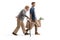 Full length profile shot of an elderly man walking with a cane and young man carrying grocery bags