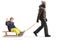 Full length profile shot of a father in winter clothes walking and pulling a boy on a sled