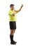 Full length profile shot of a football referee blowing a whistle and holding a yellow card