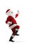 Full length profile shot of happy Santa Claus standing dancing