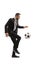 Full length profile shot of a man in a suit kicking a football