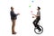 Full length profile shot of a mature man giving an applause to a mime on a unicycle juggling with balls