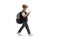 Full length profile shot of a schoolboy walking and typing on a smartphone