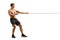 Full length profile shot of a strong young shirtless man pulling a rope