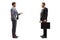 Full length profile shot of two businessmen standing and talking