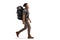 Full length profile shot of a young bearded man with a backpack and hiking equipment walking