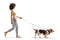 Full length profile shot of a young female walking a basset hound dog on a lead