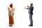 Full length profile shot of a young man and a woman with a hijab meeting and greeting each other