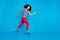 Full length profile side photo of cheerful crazy afro american girl jump run fast after spring discounts wear striped t